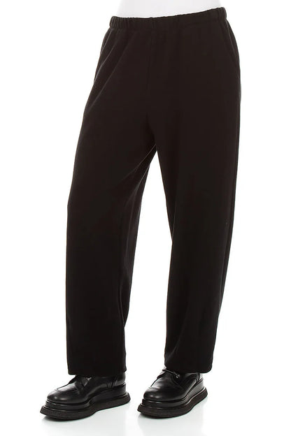Lange, schmal zulaufende Hose aus schwarzem Baumwolljersey