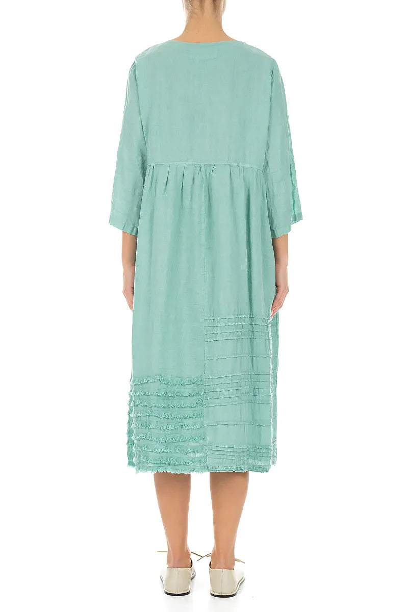 Robe en lin vert menthe à smocks et ourlet effiloché