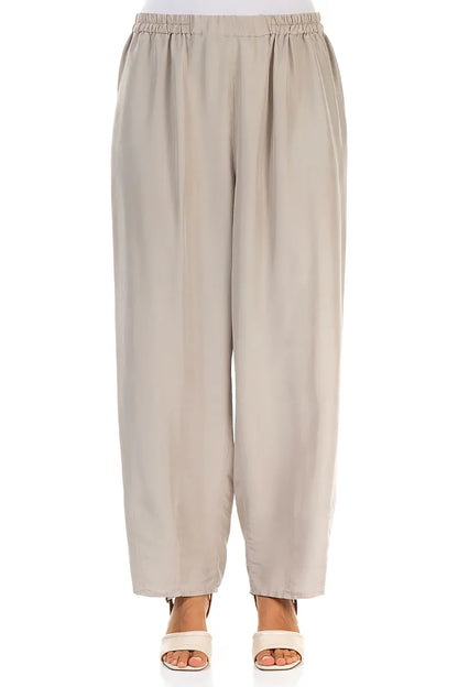 Schmal zulaufende beige Seidenhose